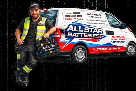 Allstar Batteries technician Daniel in safety gear poses next to white service van